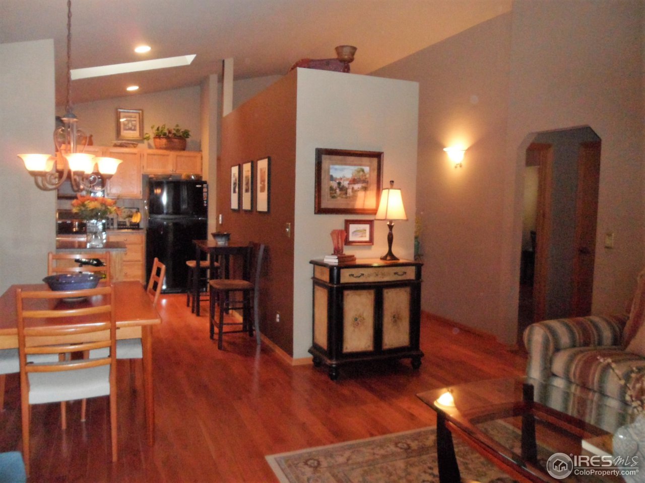 724 Wade Road Longmont, CO 80503 - Photo 6 of 32 a living room with furniture and wooden floor