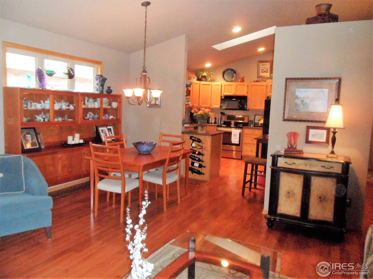 724 Wade Road Longmont, CO 80503 - Photo 9 of 32 a view of a dining room with furniture and wooden floor