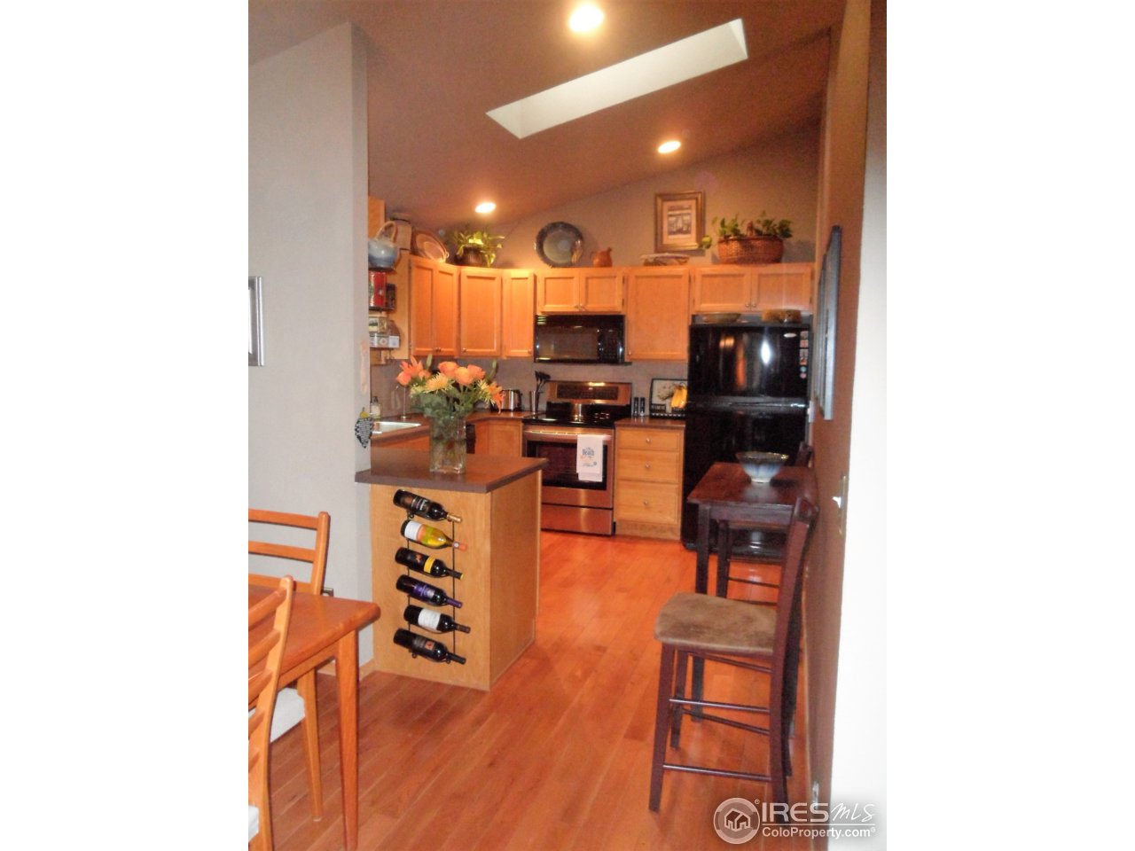 724 Wade Road Longmont, CO 80503 - Photo 10 of 32 a living room with furniture and wooden floor