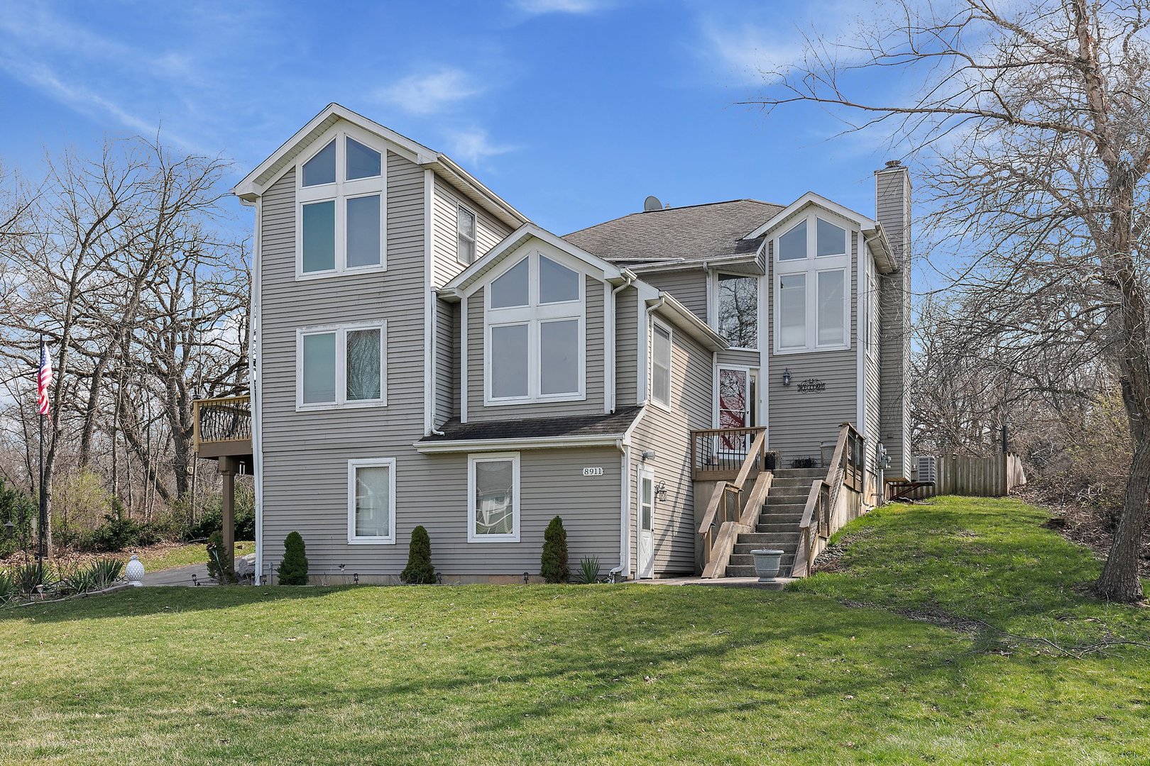 8911 Burton Road Wonder Lake, IL 60097 - Photo 1 of 35 a front view of a house with a yard