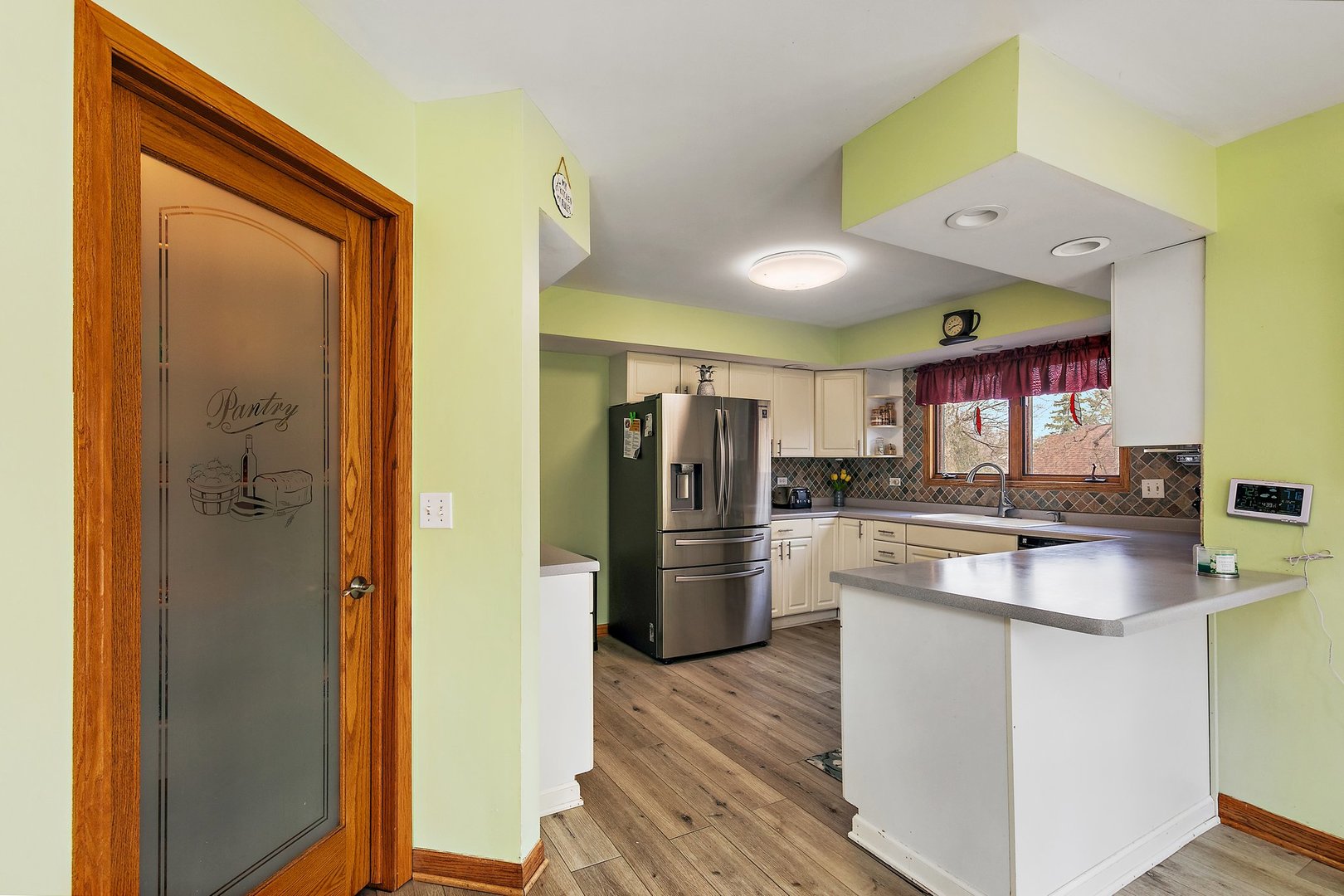 8911 Burton Road Wonder Lake, IL 60097 - Photo 13 of 35 a kitchen with a refrigerator and a sink