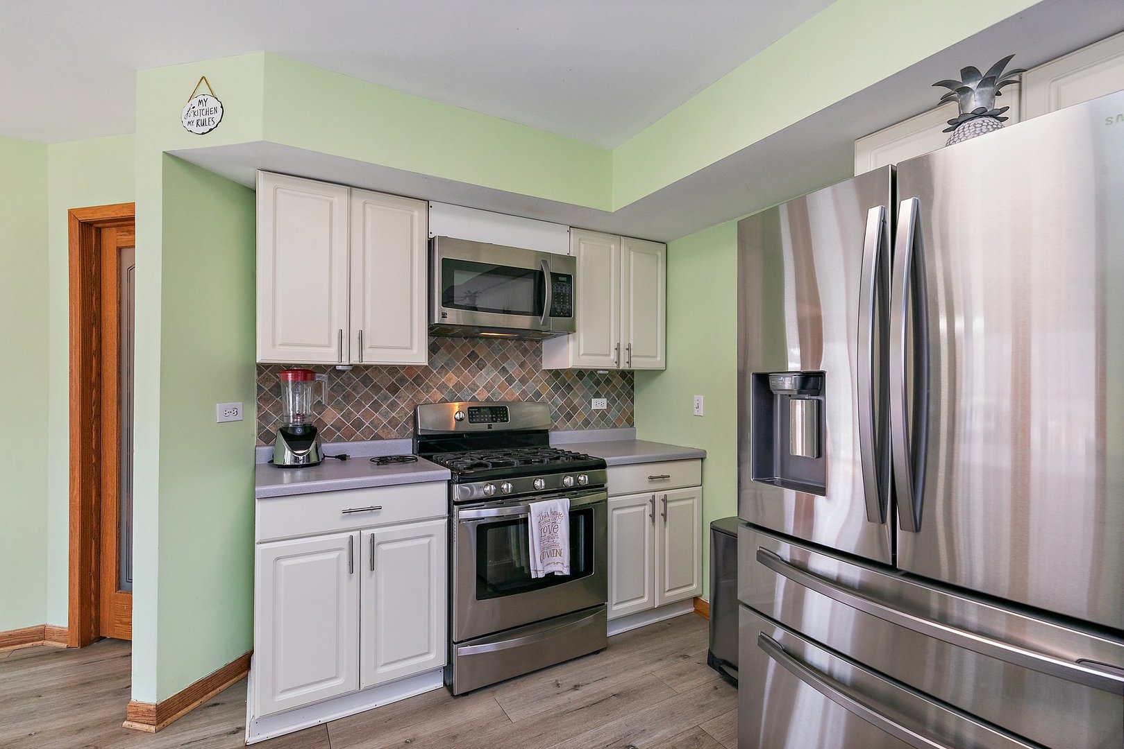 8911 Burton Road Wonder Lake, IL 60097 - Photo 16 of 35 a kitchen with stainless steel appliances white cabinets and a stove top oven