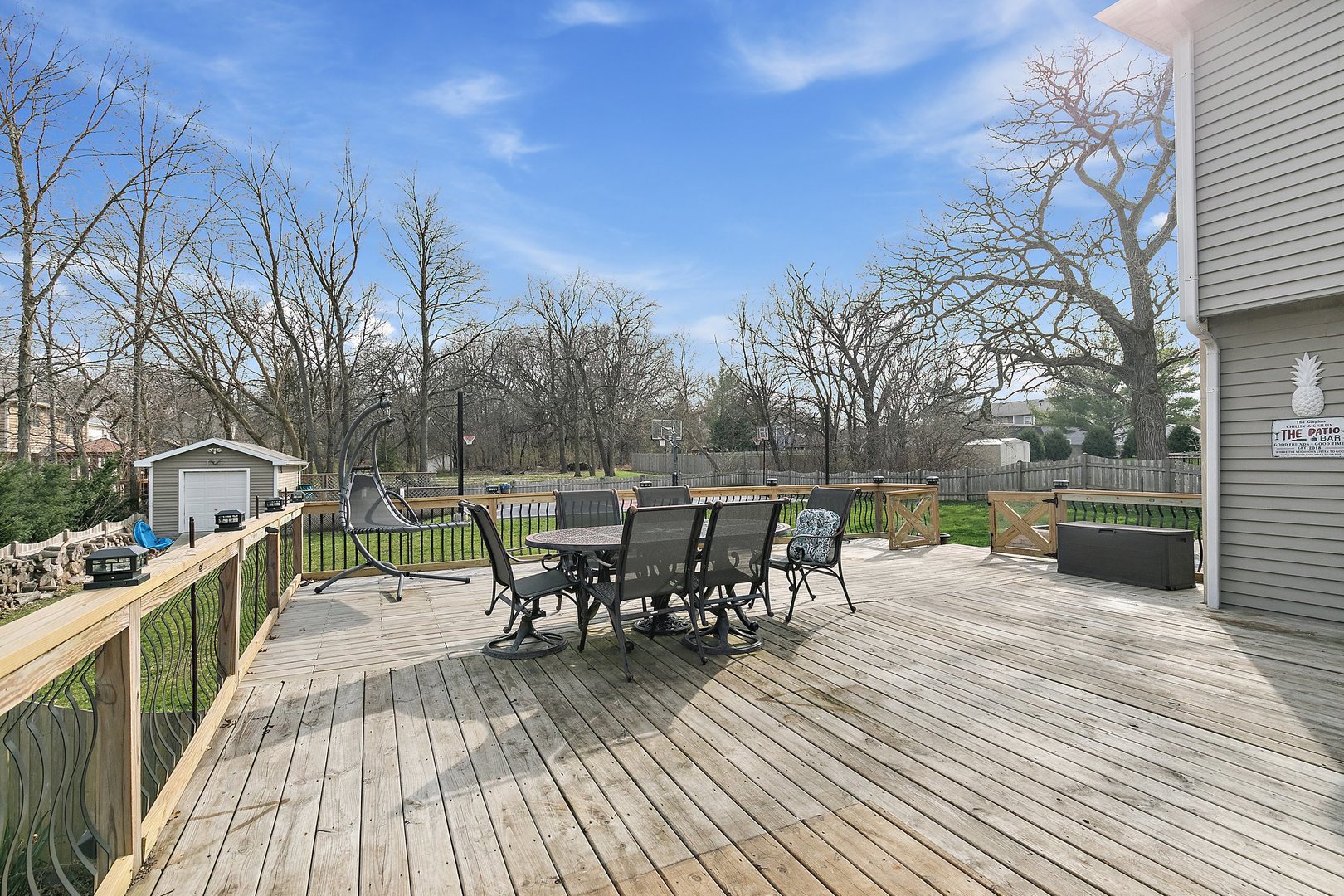 8911 Burton Road Wonder Lake, IL 60097 - Photo 32 of 35 a view of a roof deck with table and chairs a barbeque with wooden floor and fence