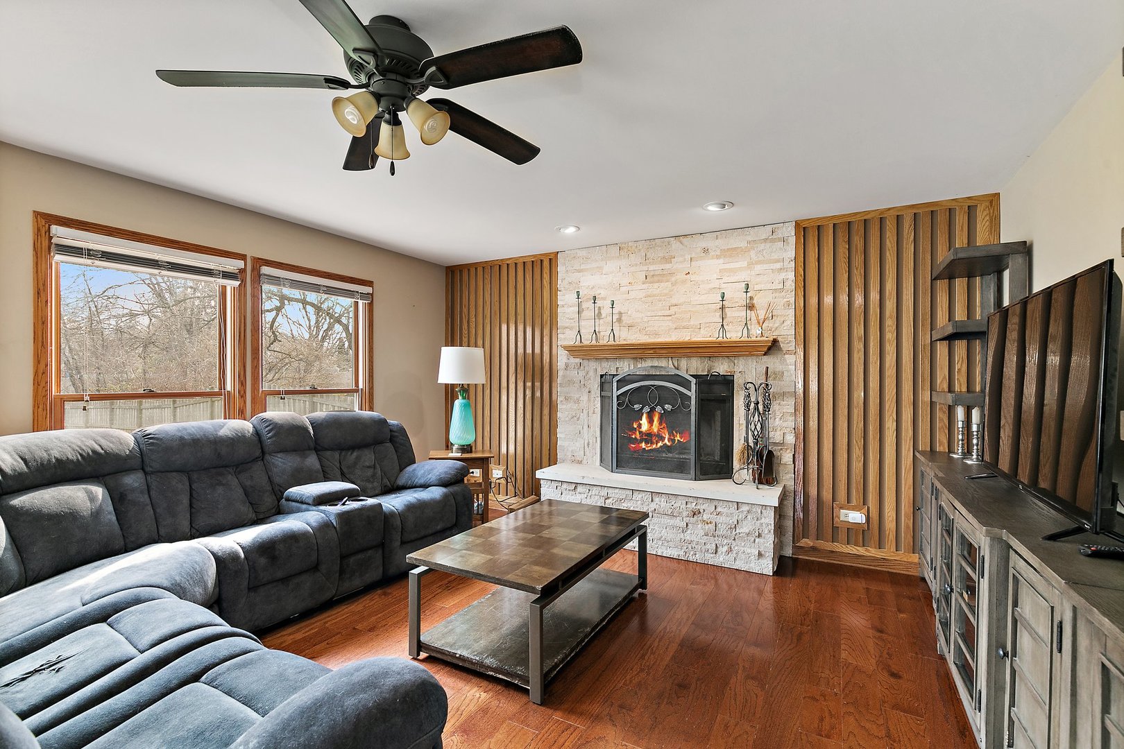 8911 Burton Road Wonder Lake, IL 60097 - Photo 8 of 35 a living room with furniture and a fireplace