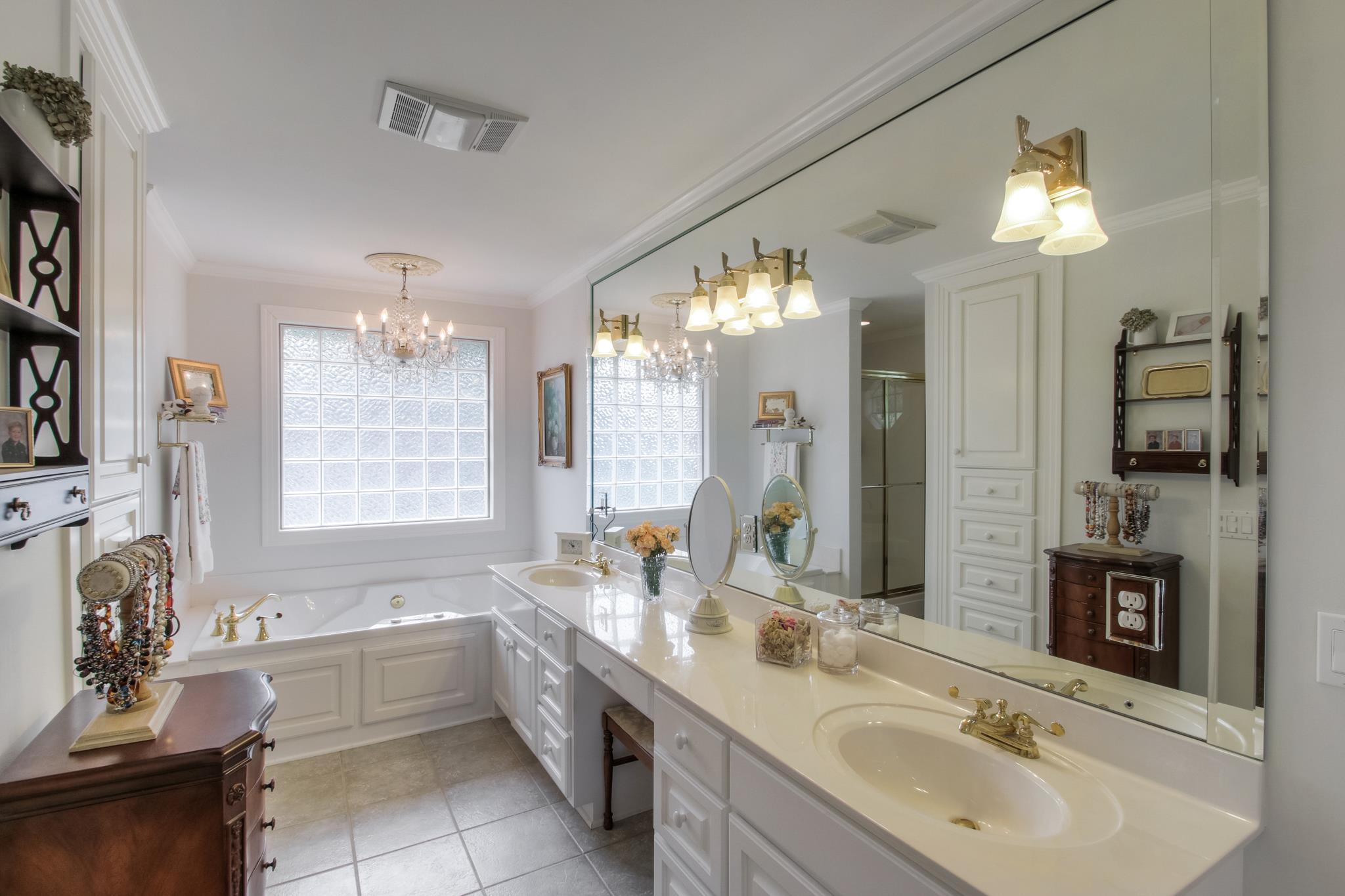 1160 Vanderbilt Road Mount Juliet, TN 37122 - Photo 14 of 28 a bathroom with a tub a sink double vanity and a mirror