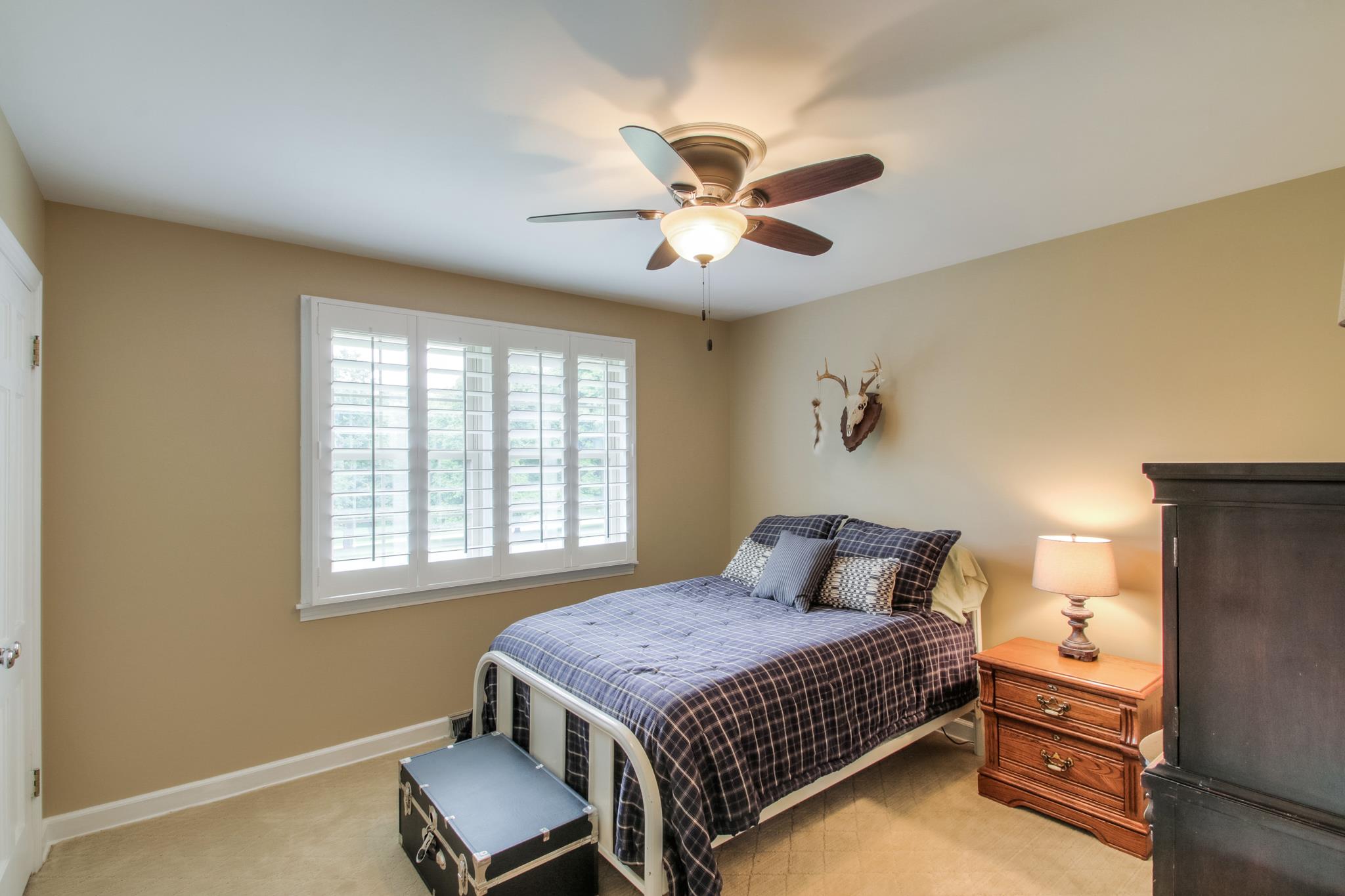 1160 Vanderbilt Road Mount Juliet, TN 37122 - Photo 16 of 28 a bedroom with a bed and a chandelier