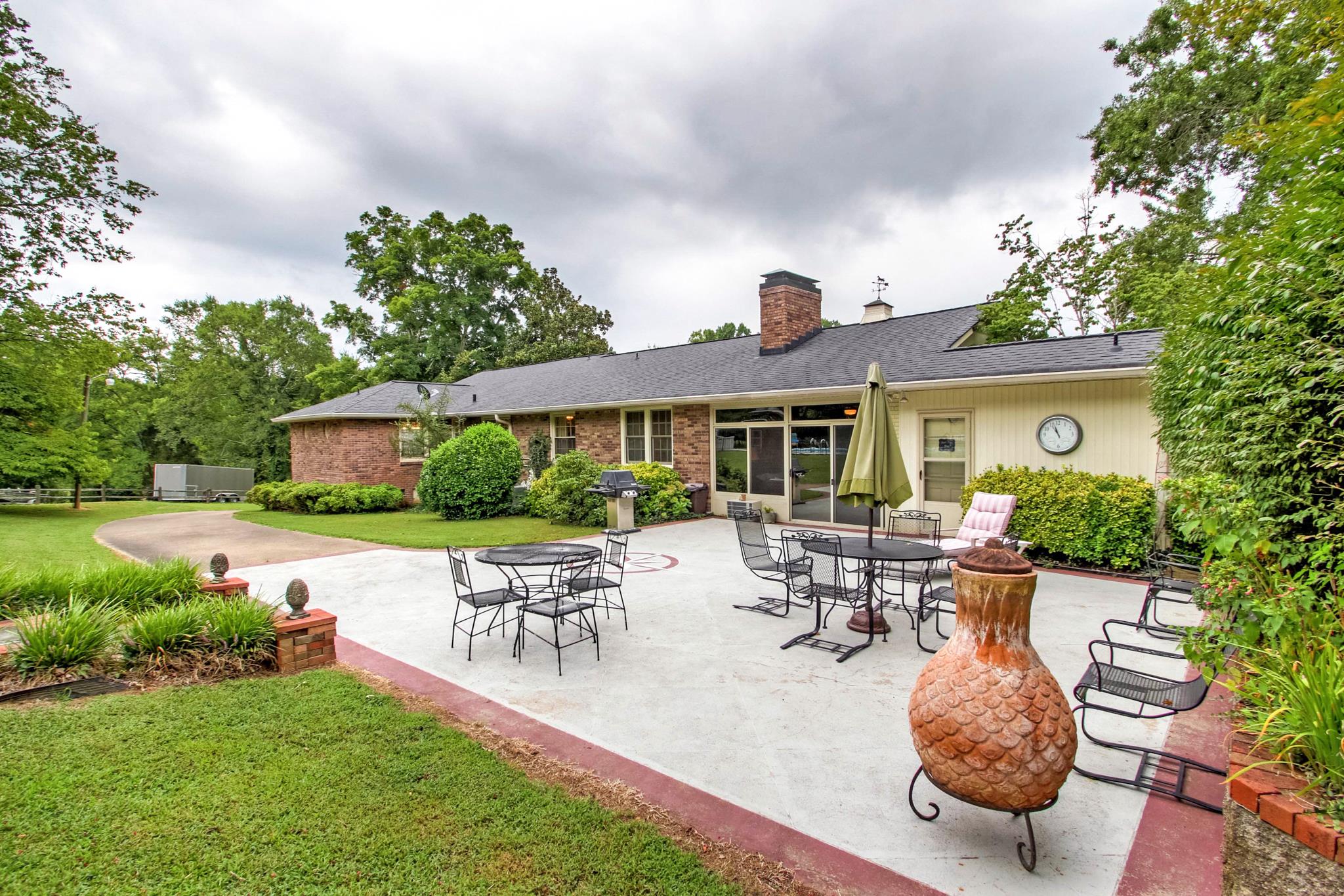 1160 Vanderbilt Road Mount Juliet, TN 37122 - Photo 25 of 28 a view of a patio with table and chairs potted plants and a large tree