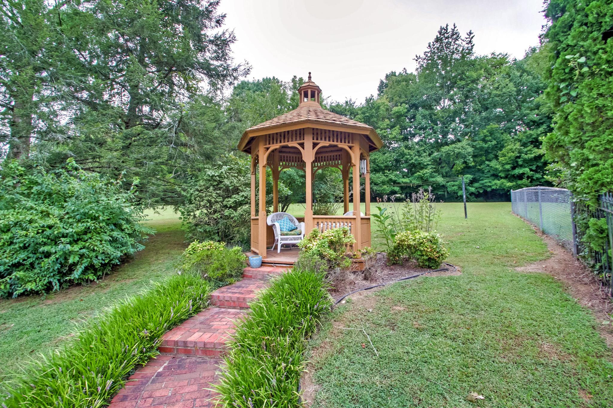 1160 Vanderbilt Road Mount Juliet, TN 37122 - Photo 26 of 28 a front view of a house with a yard table and chairs