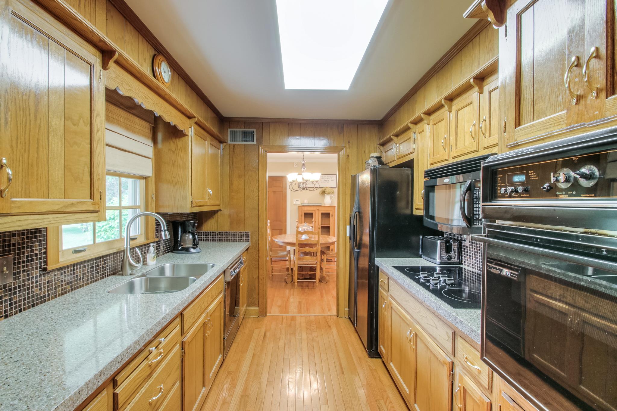 1160 Vanderbilt Road Mount Juliet, TN 37122 - Photo 9 of 28 a kitchen with stainless steel appliances granite countertop a sink and wooden cabinets