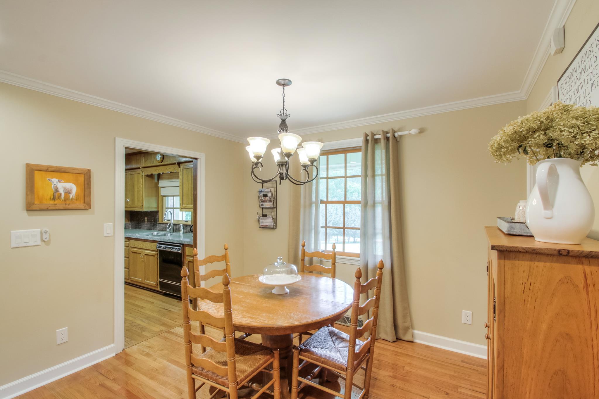 1160 Vanderbilt Road Mount Juliet, TN 37122 - Photo 10 of 28 a view of a dining room with furniture and chandelier
