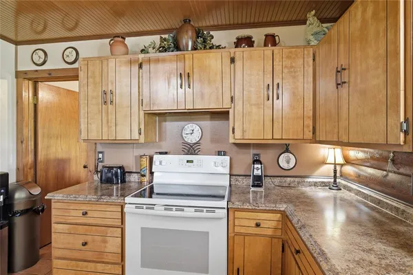 a kitchen with a stove a sink and a refrigerator