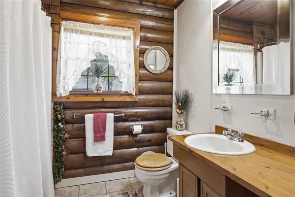 a bathroom with a toilet a sink and a mirror