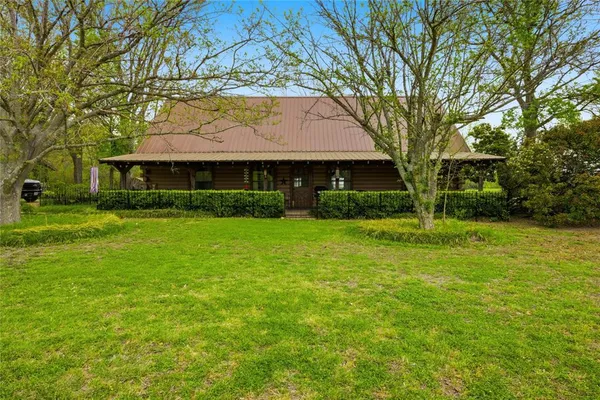 a front view of house with yard and green space