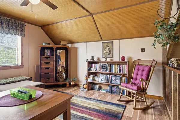 a living room with furniture and a book shelf