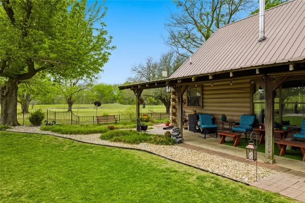 a view of a house with backyard and sitting area
