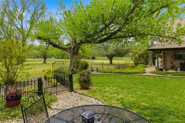 a view of yard with swimming pool and green space