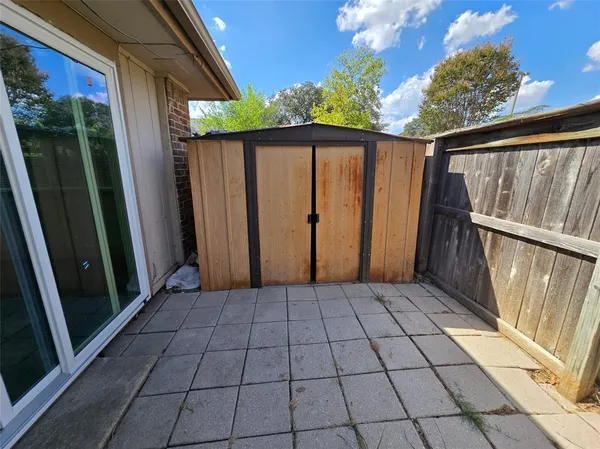 a view of a balcony with wooden floor and fence