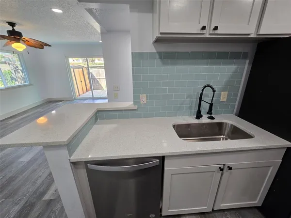 a kitchen with a sink and cabinets