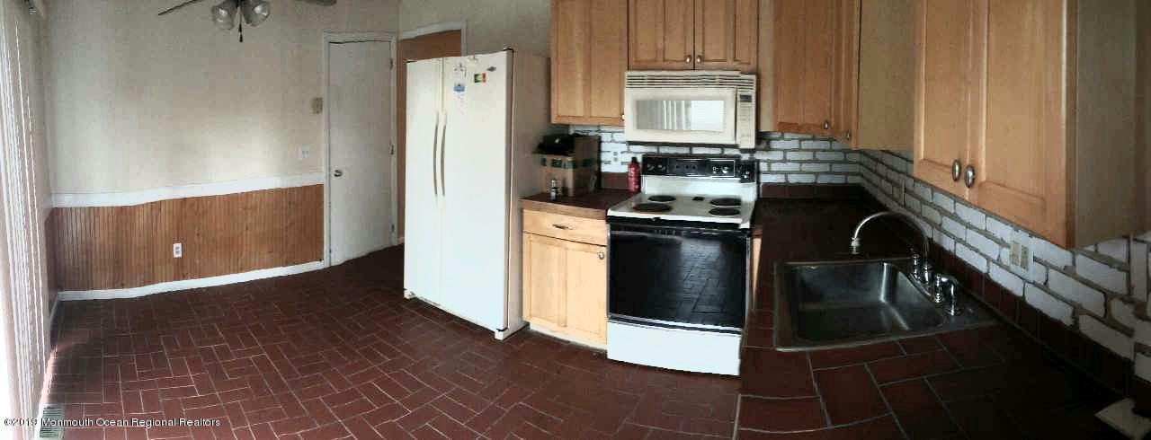 86 Port Road Brick, NJ 08723 - Photo 3 of 7 a kitchen with stainless steel appliances granite countertop a refrigerator a stove and a sink