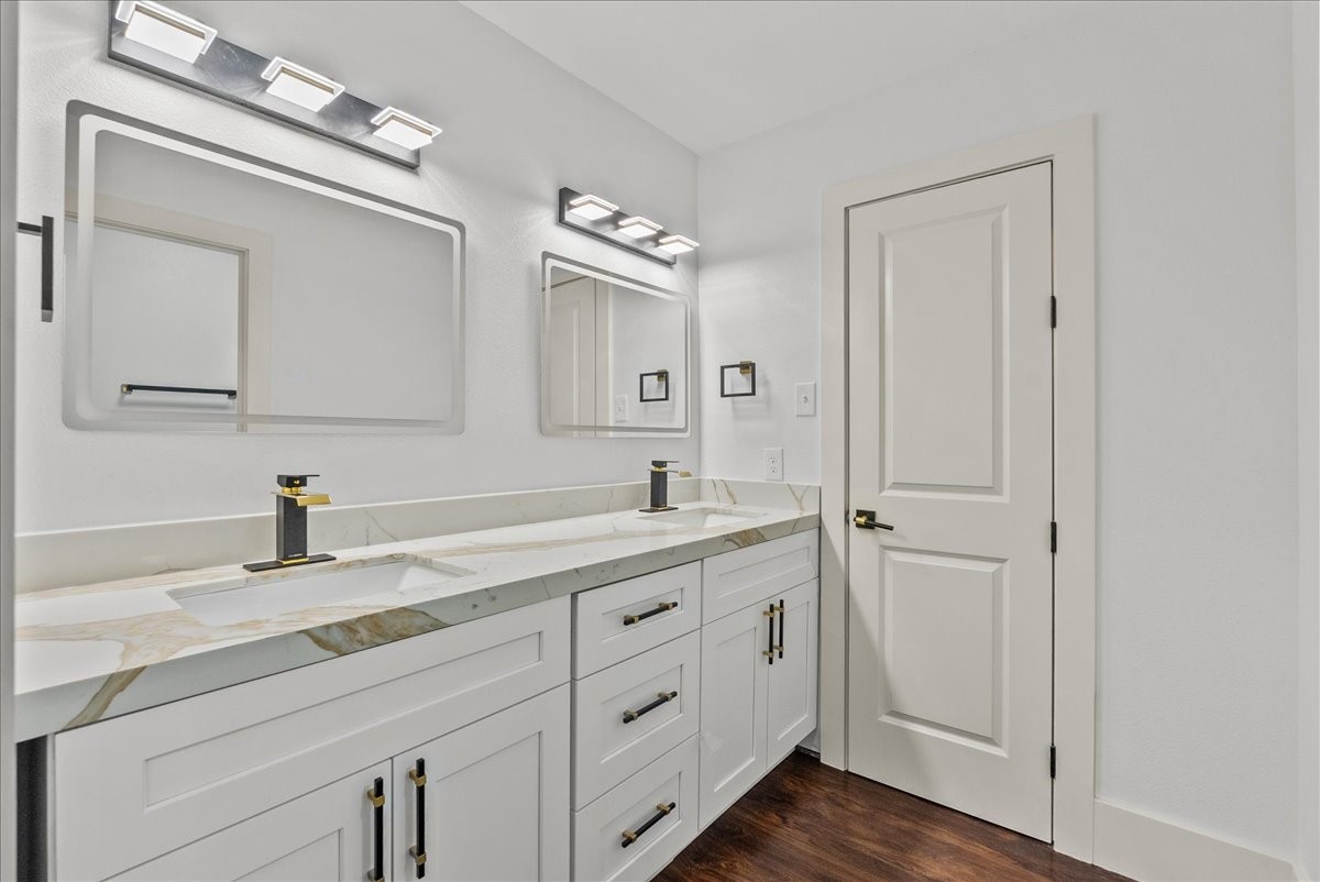 3237 Harkey Road Pearland, TX 77584 - Photo 27 of 46 Spacious upstairs bath directly across from rooms one and two, featuring dual sinks and custom cabinetry.