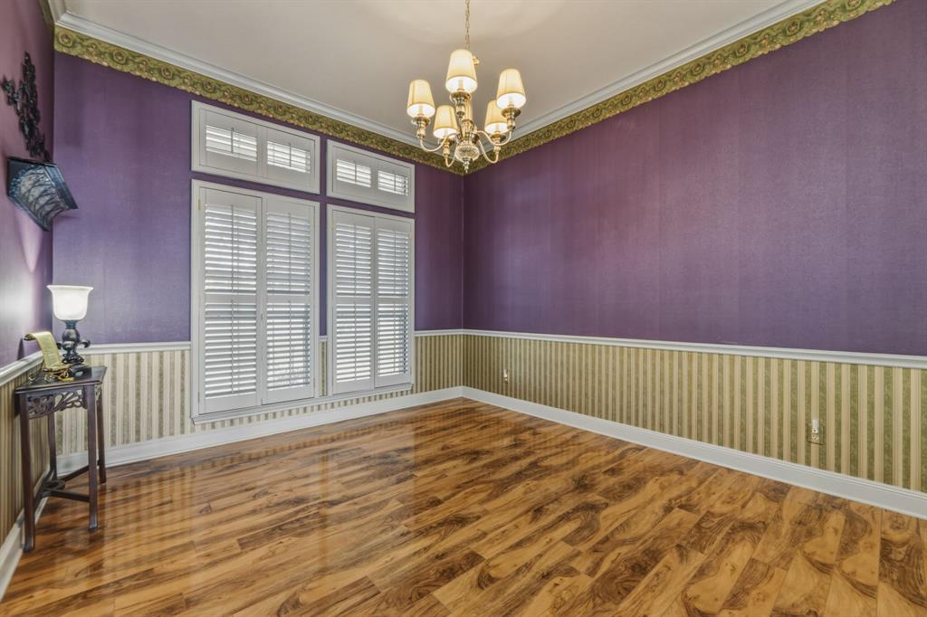 130 Blazek Road Alma, TX 75119 - Photo 9 of 34 a view of a livingroom with wooden floor and a chandelier