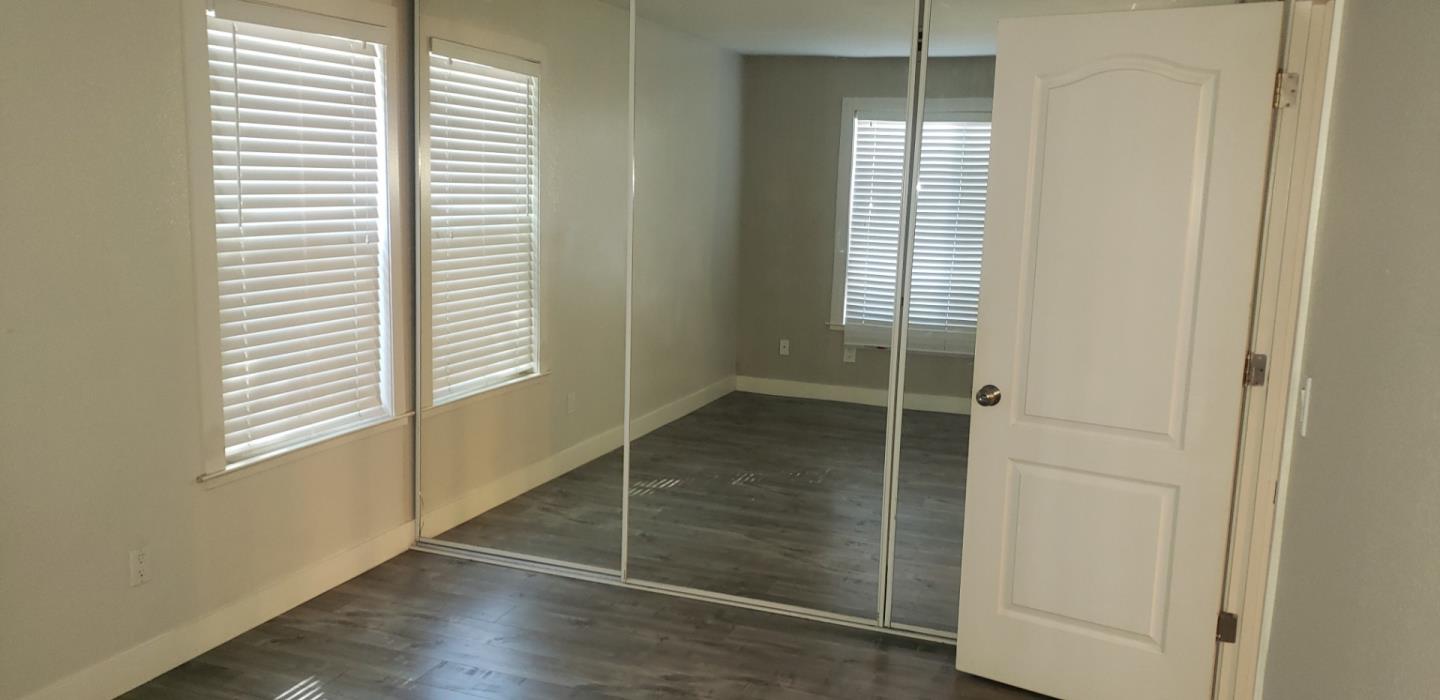 215 Reflections Drive, Unit 15 San Ramon, CA 94583 - Photo 4 of 14 a view of an empty room with wooden floor and a window