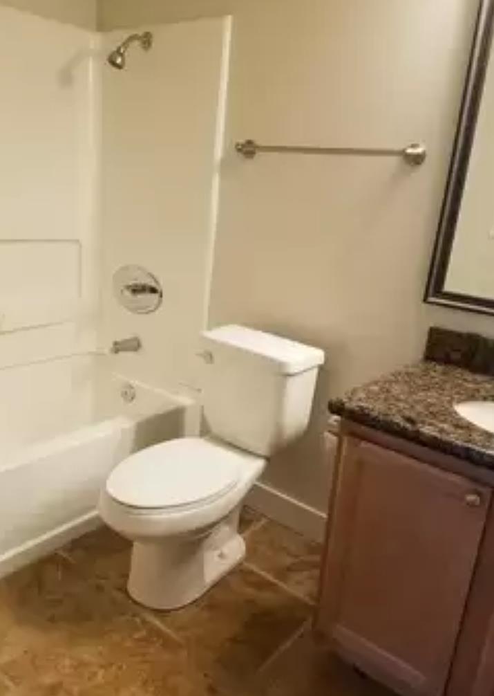 215 Reflections Drive, Unit 15 San Ramon, CA 94583 - Photo 6 of 14 a white toilet sitting next to a bath tub