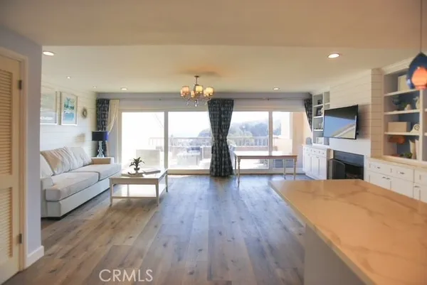 a living room with fireplace furniture and a wooden floor