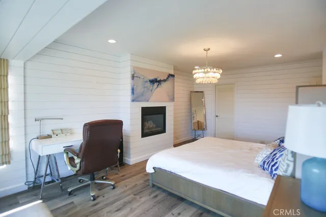 a spacious bedroom with a bed and a chandelier