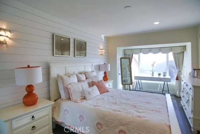 a bedroom with a bed and a large window