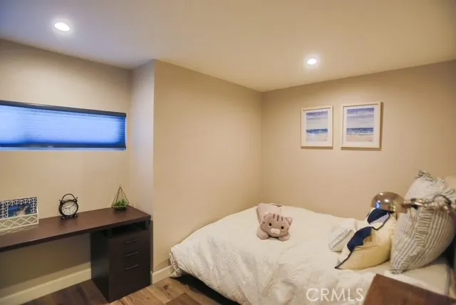 a bedroom with a bed and with wooden floor