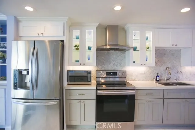 a kitchen with a sink stove and refrigerator