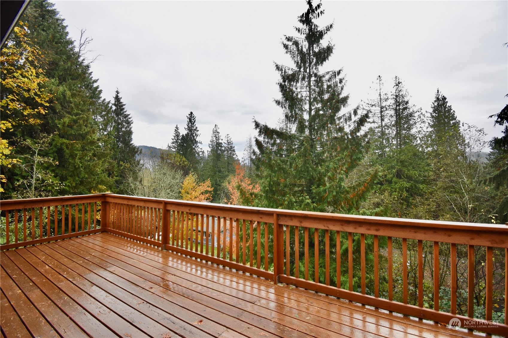 738 W Road Sedro-Woolley, WA 98284 - Photo 11 of 17 a view of balcony with wooden floor and trees in the background