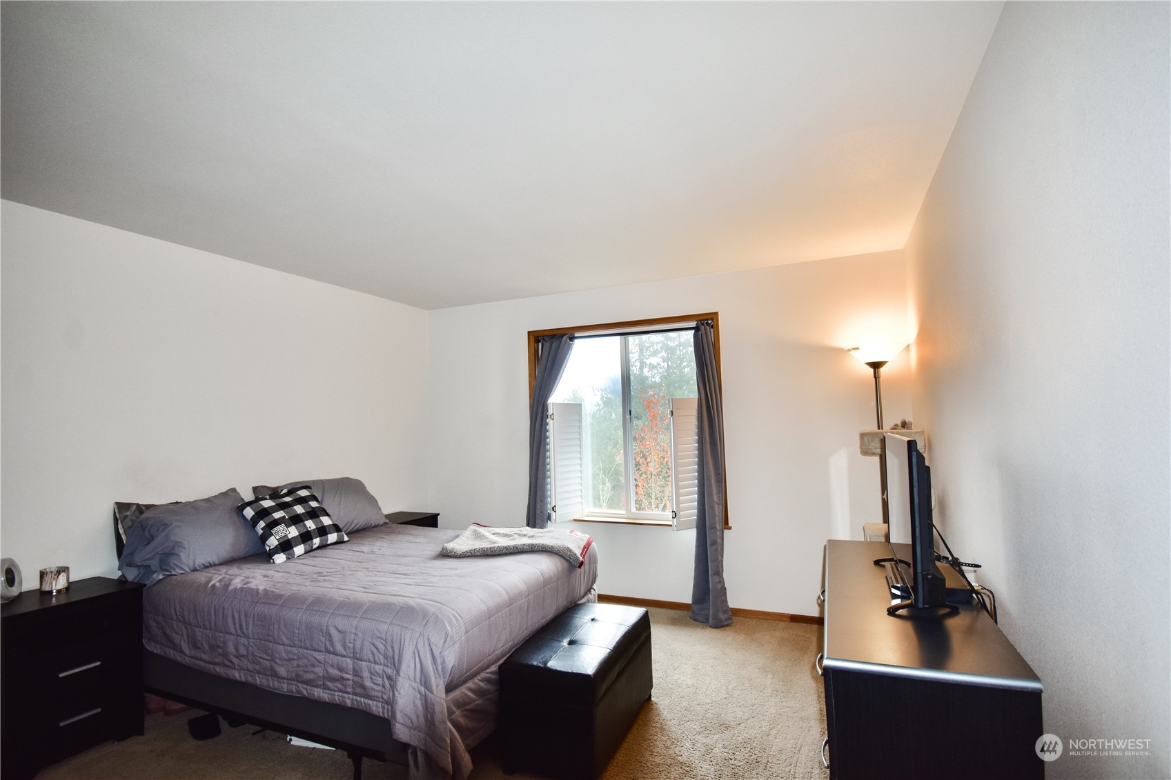 738 W Road Sedro-Woolley, WA 98284 - Photo 7 of 17 a bedroom with a bed and a flat tv screen on a dresser