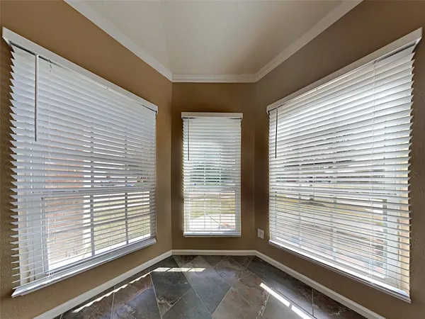 a view of an empty room and a window