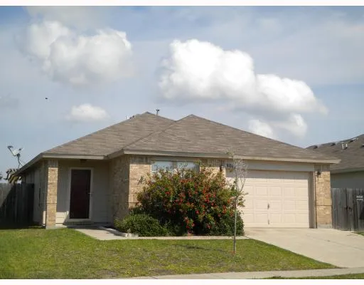 a view of a house with brick walls