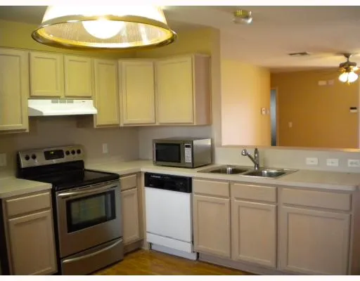 a kitchen with stainless steel appliances granite countertop a sink and cabinets