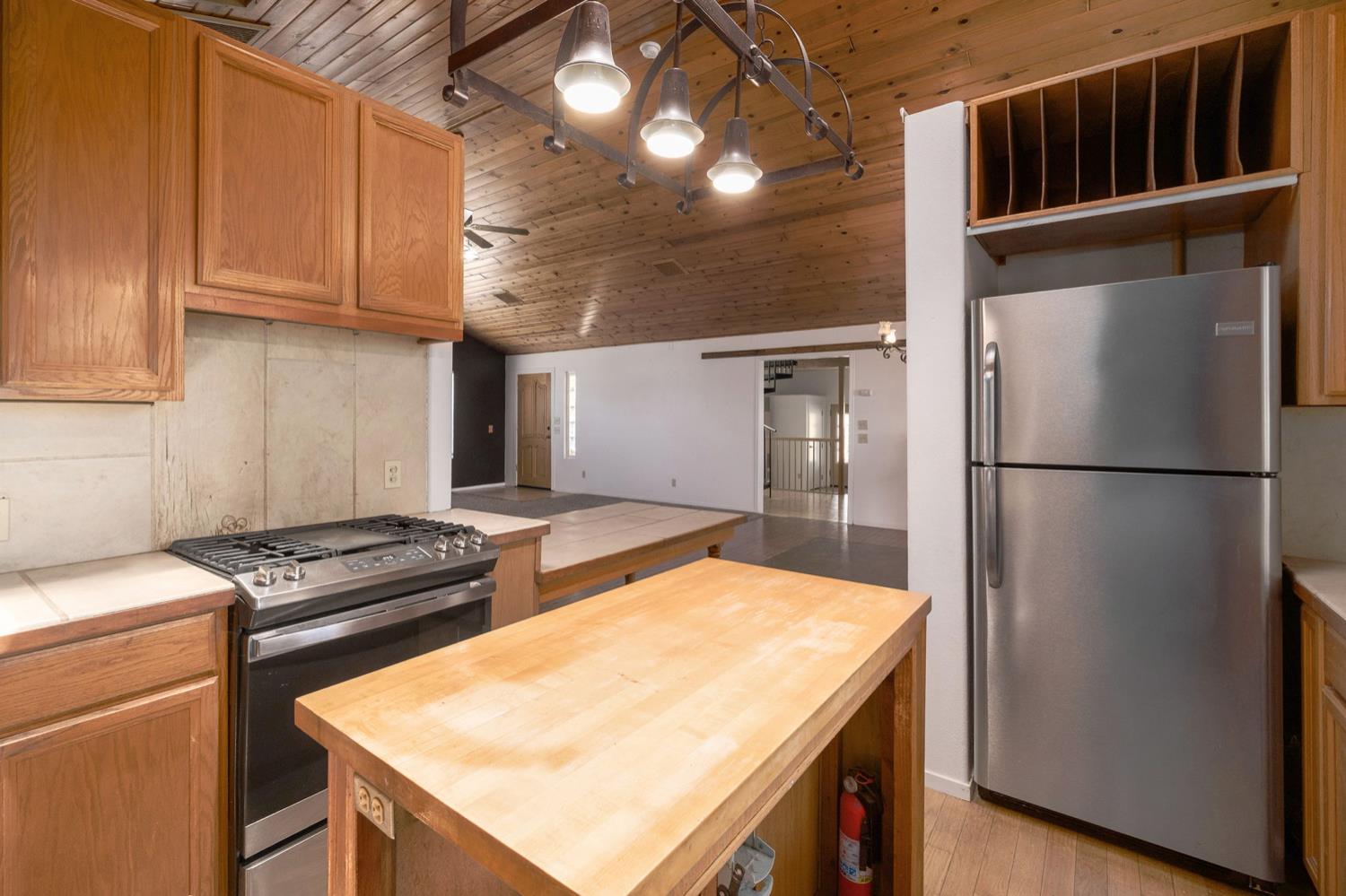 37667 Eagle Drive Raymond, CA 93653 - Photo 11 of 43 a kitchen that has a cabinets and a stove