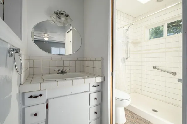 a bathroom with a sink toilet and shower