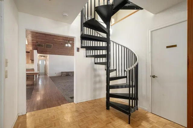 a view of a hallway with wooden floor and entryway