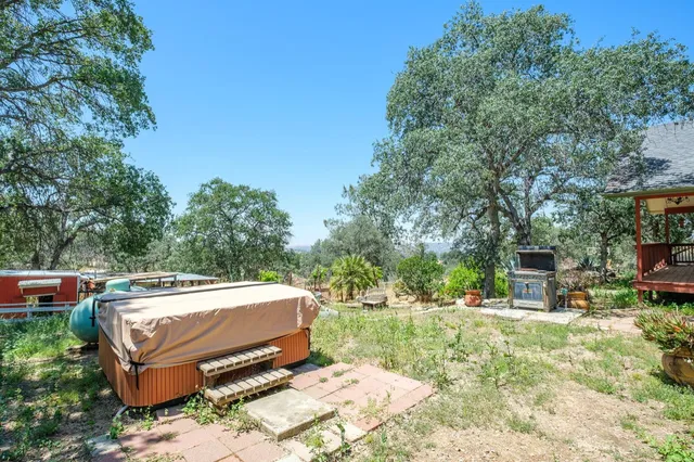 a view of a backyard with sitting area