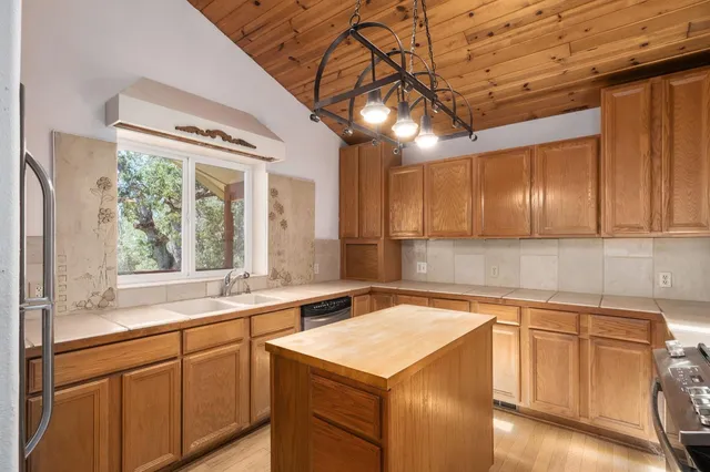 a kitchen with a sink window and cabinets