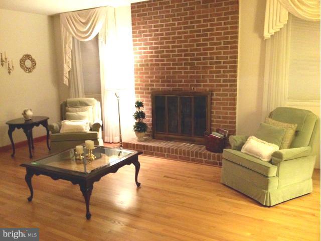 9104 Ramblebrook Road Baltimore, MD 21236 - Photo 2 of 17 a living room with furniture and a fireplace