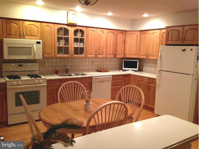 9104 Ramblebrook Road Baltimore, MD 21236 - Photo 3 of 17 a kitchen with stainless steel appliances a stove a sink a microwave a refrigerator and cabinets