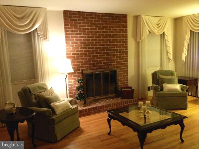 9104 Ramblebrook Road Baltimore, MD 21236 - Photo 4 of 17 a living room with furniture and a fireplace