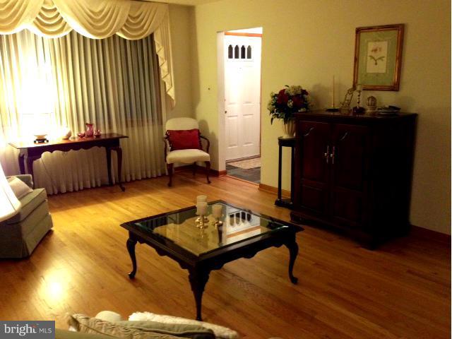 9104 Ramblebrook Road Baltimore, MD 21236 - Photo 7 of 17 a living room with furniture and a wooden floor