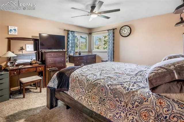 a bedroom with a bed and a television