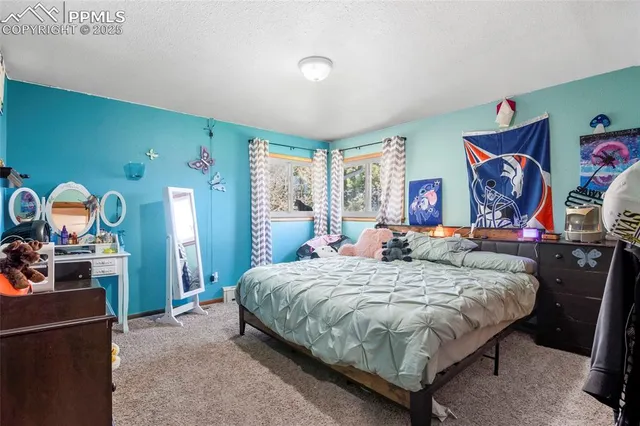 a bedroom with a bed and dresser with mirror