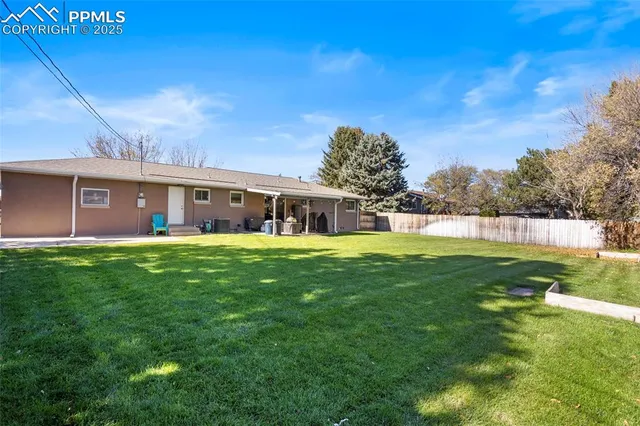 a front view of house with a garden