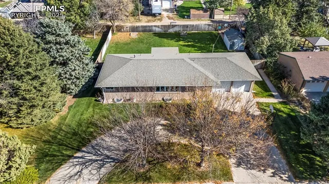 an aerial view of a house with yard swimming pool and outdoor seating